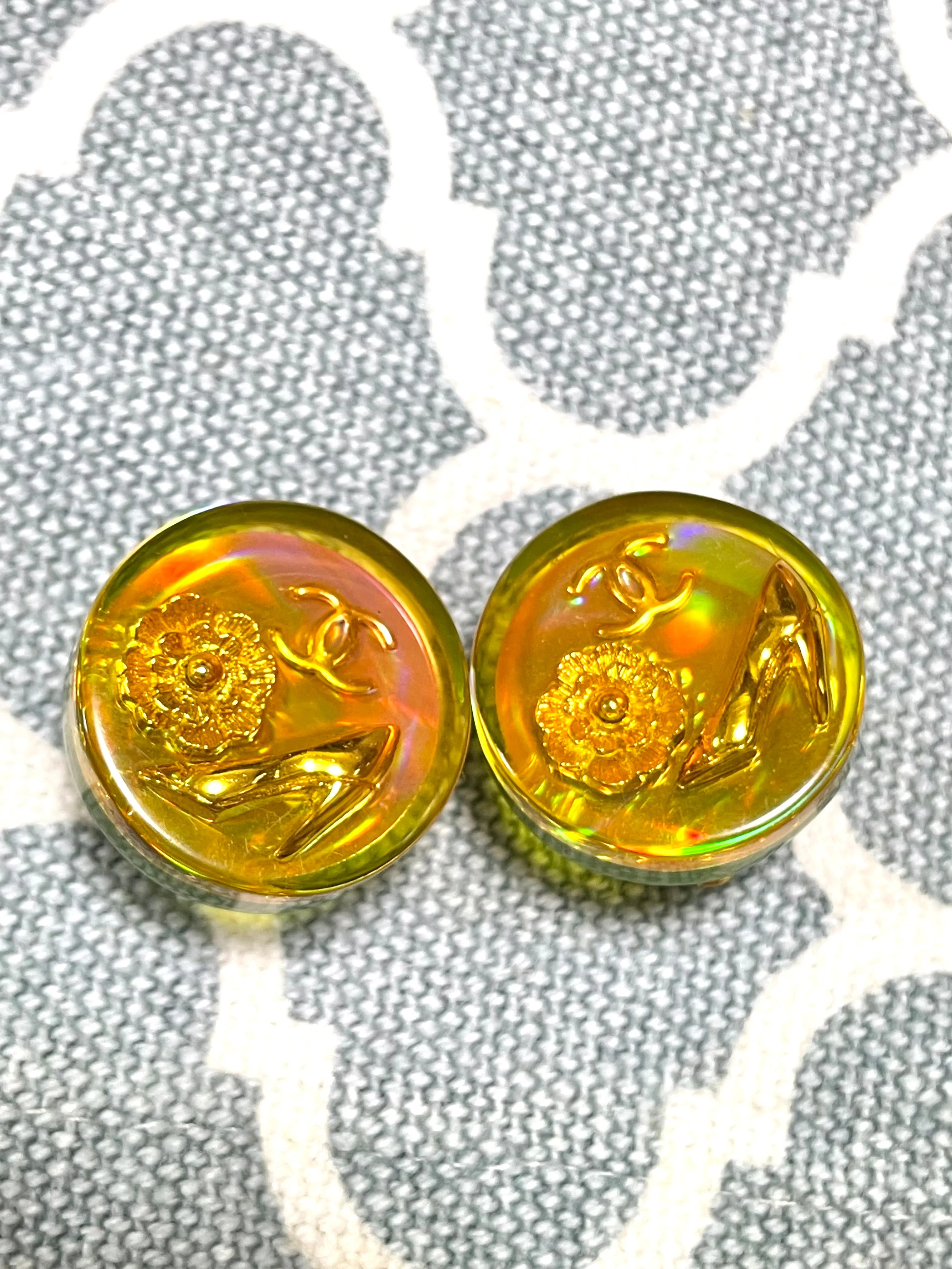 Vintage CHANEL yellow orange tone aurora resin earrings with Chanel iconic charms. Golden shoe, camellia, and CC mark in it. 041228an1
